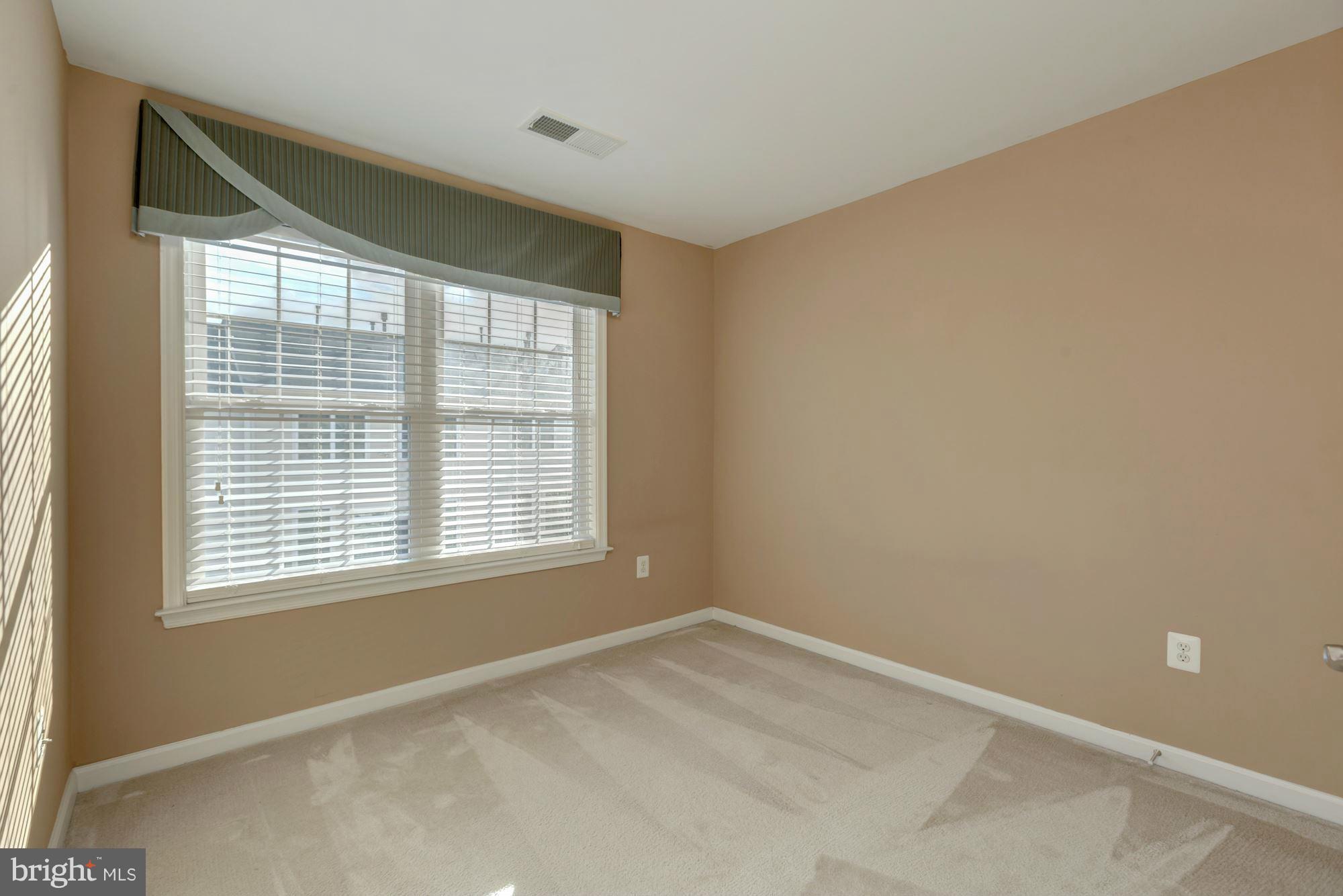 397 Spring Street Herndon, VA 20170 - Photo 20 of 30 a view of an empty room with a window