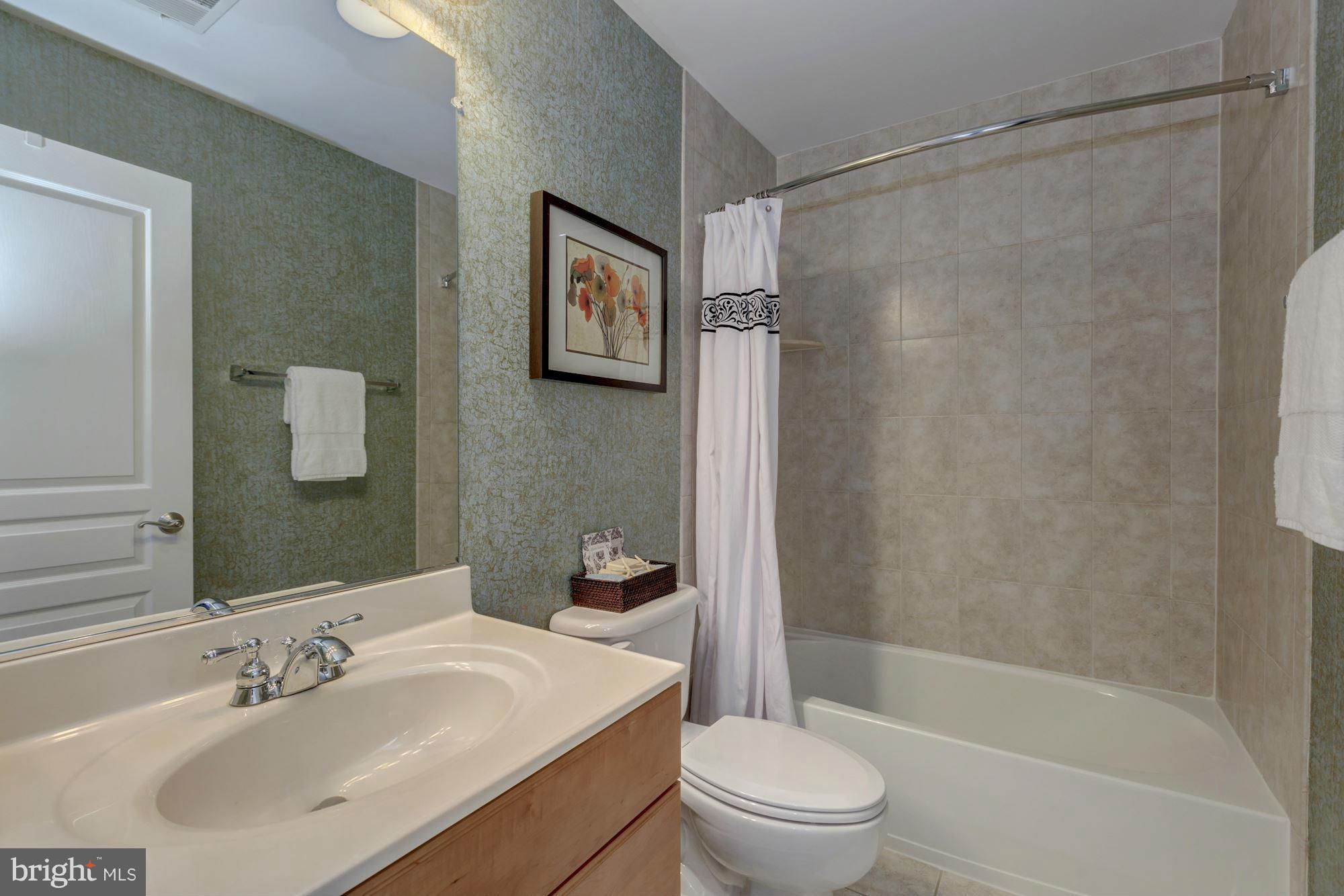 397 Spring Street Herndon, VA 20170 - Photo 21 of 30 a bathroom with a sink toilet and shower