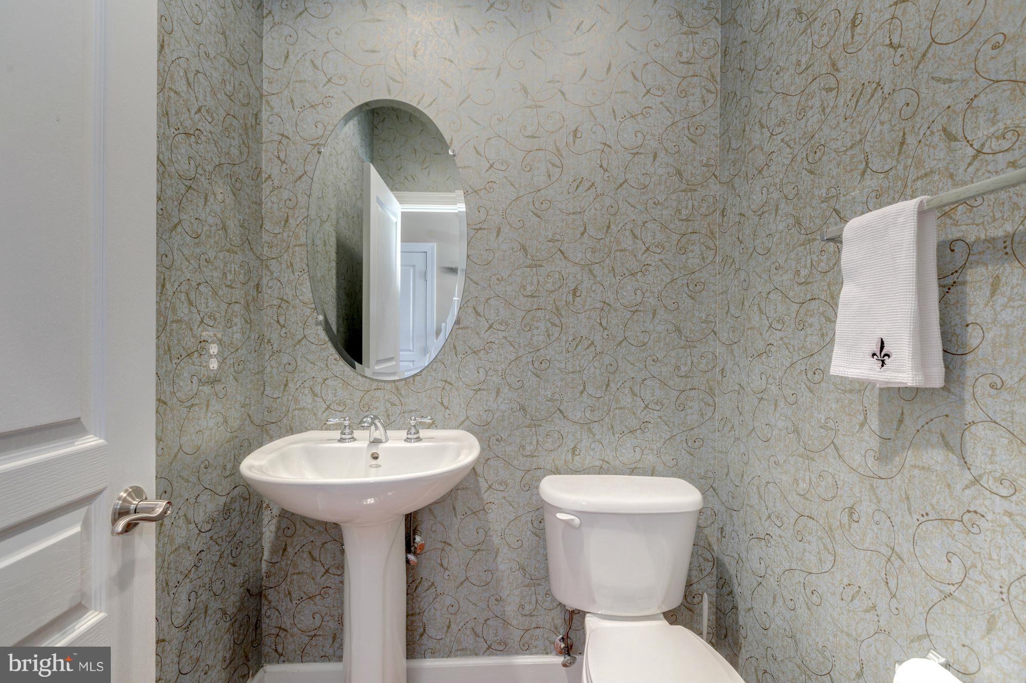 397 Spring Street Herndon, VA 20170 - Photo 24 of 30 a bathroom with a toilet sink and mirror
