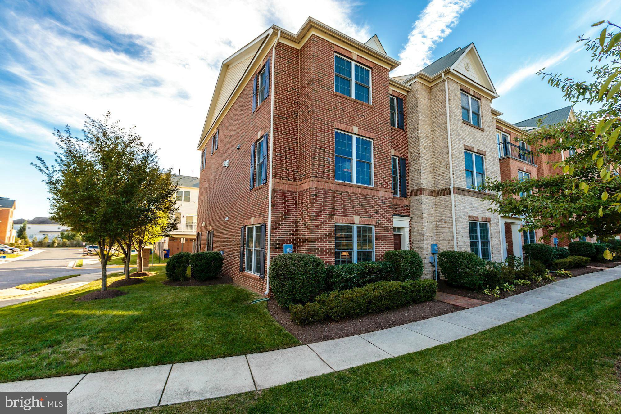 397 Spring Street Herndon, VA 20170 - Photo 28 of 30 a front view of a house with garden and trees