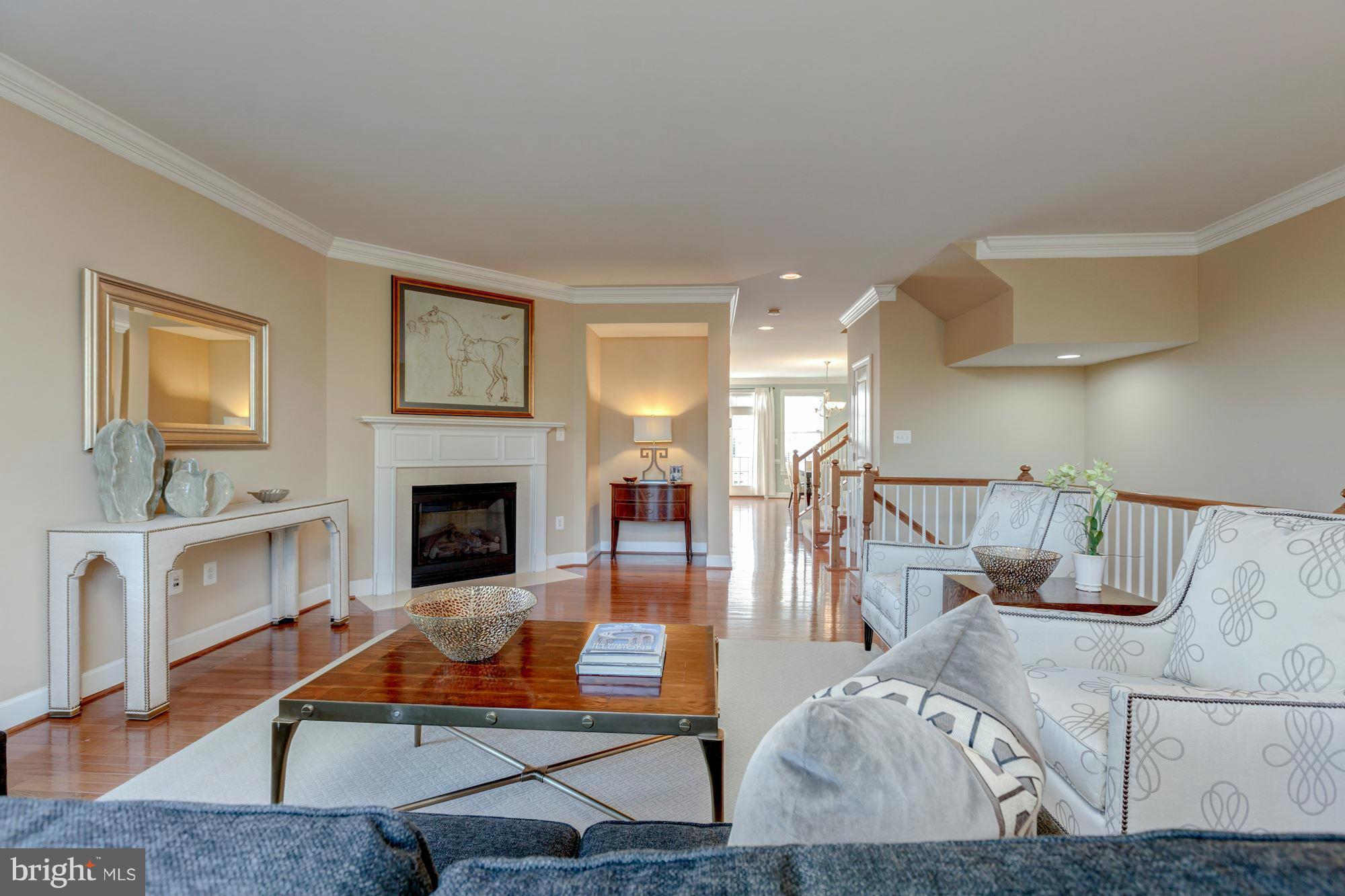 397 Spring Street Herndon, VA 20170 - Photo 7 of 30 a living room with furniture a fireplace and a table
