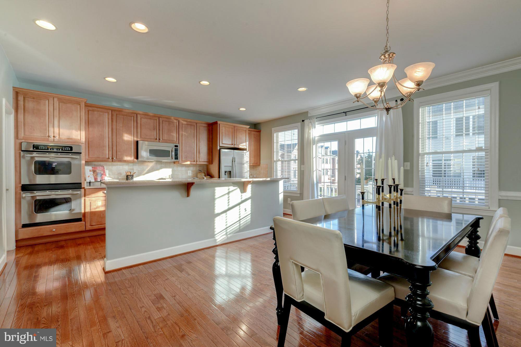 397 Spring Street Herndon, VA 20170 - Photo 9 of 30 a view of a dining room with furniture large window and wooden floor