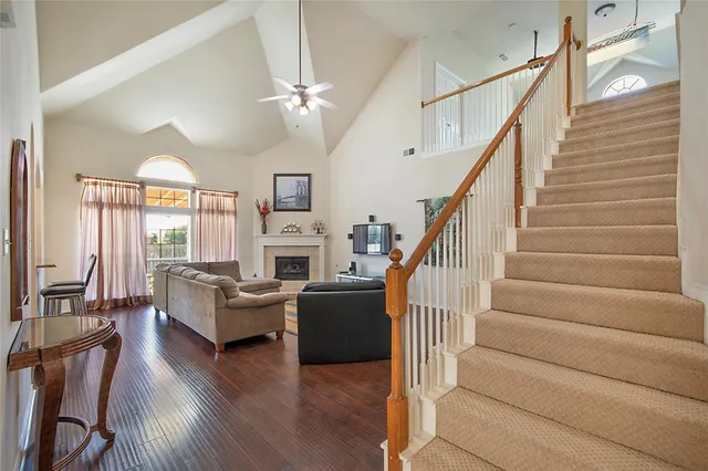 a living room with fireplace furniture and a wooden floor