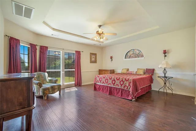 a bedroom with a bed and glass walk in closet