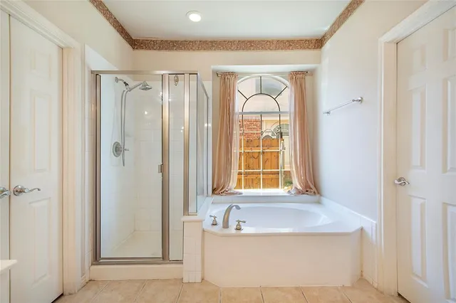 a bathroom with a tub a sink and a window