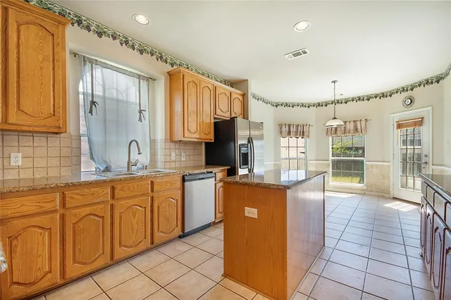a kitchen with stainless steel appliances granite countertop a sink and cabinets
