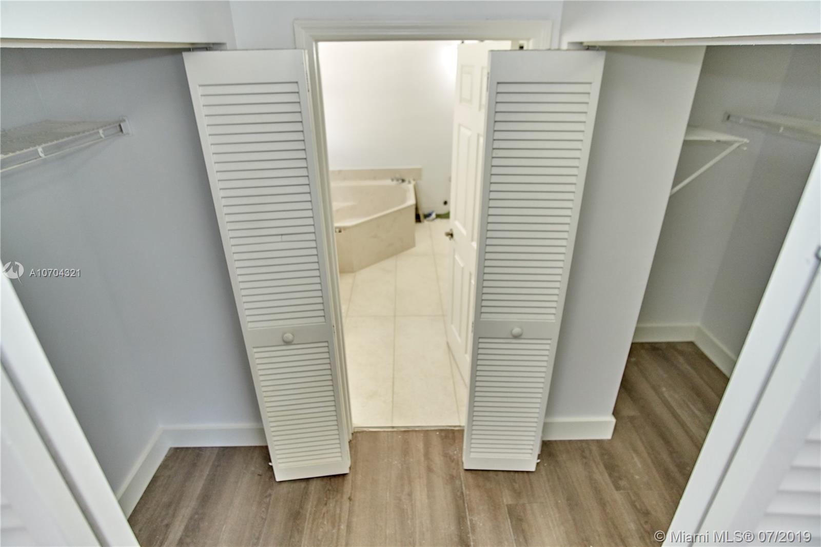 10646 Wheelhouse Circle Boca Raton, FL 33428 - Photo 23 of 34 MASTER BEDROOM- CLOSET (LEFT) AND WALK-IN CLOSET RIGHT