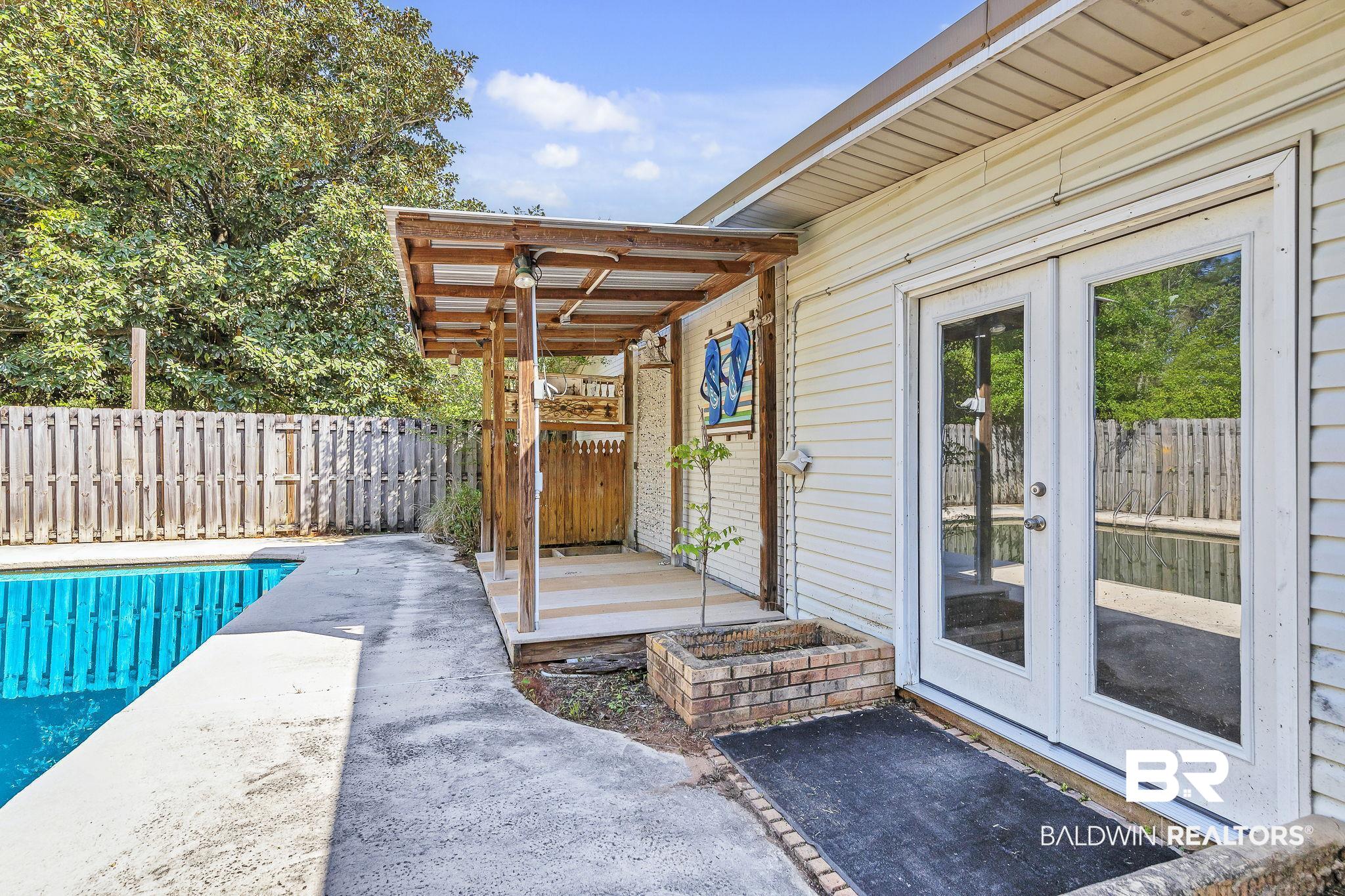 11964 Stroh Road Daphne, AL 36527 - Photo 58 of 58 View of pool featuring french doors, fence, a fenced in pool, and a patio