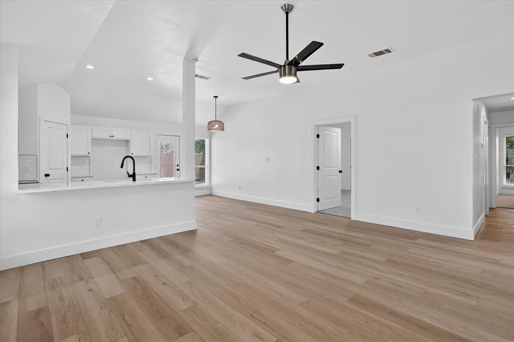 6021 Hartman Road Forest Hill, TX 76119 - Photo 7 of 27 a view of a kitchen with a sink dishwasher a refrigerator and wooden floor
