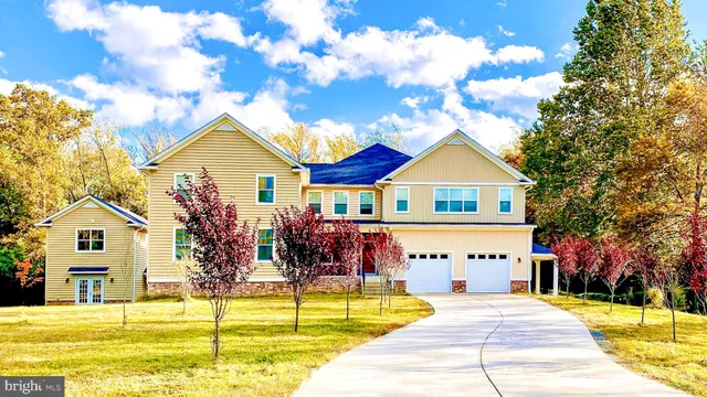 a view of a house with swimming pool and sitting area