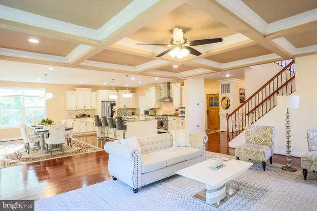 a kitchen with granite countertop a stove and a white wooden cabinets