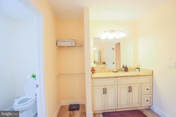 a view of bathroom with a shower and a mirror