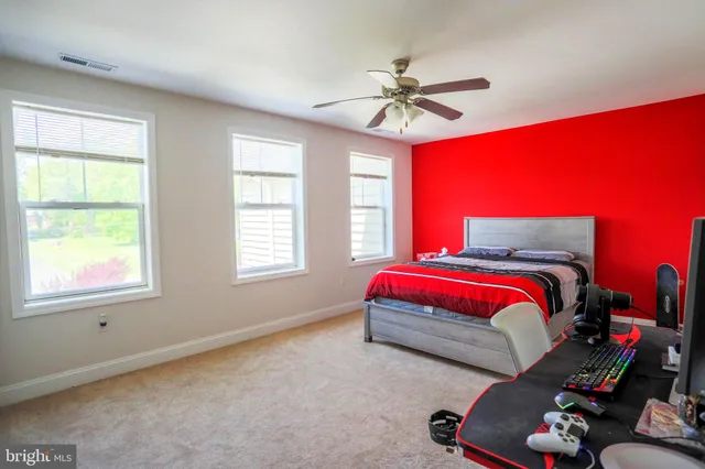 a living room with furniture and a painting on the wall