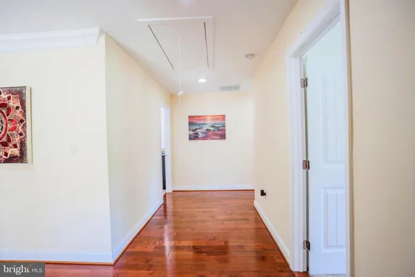 a view of a workspace with furniture and wooden floor