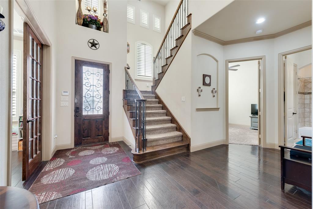 5056 Empire Way Irving, TX 75038 - Photo 10 of 39 Inviting Foyer with ornamental molding, dark wood-type flooring, and a wealth of natural light