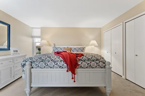 a bedroom with a large bed and a window