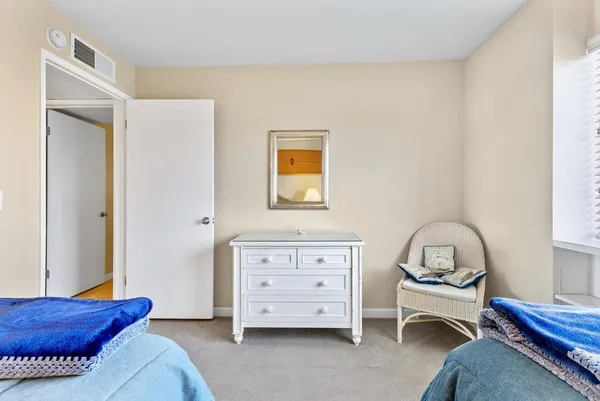 a bedroom with a bed and a dresser