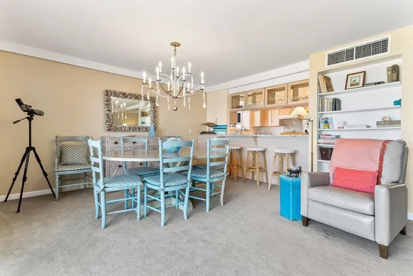 a view of a dining room with furniture and chandelier
