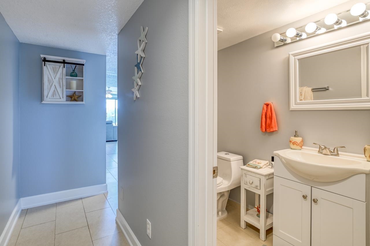 120 Sunset Harbor Way, Unit 204 St. Augustine, FL 32080 - Photo 11 of 49 a bathroom with a sink toilet and mirror