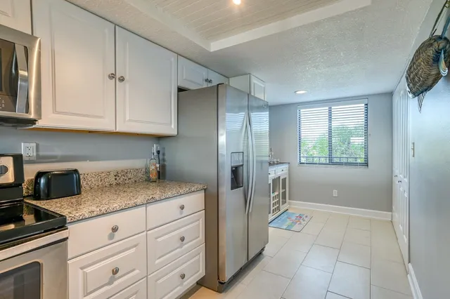 a kitchen with a refrigerator stove and cabinets