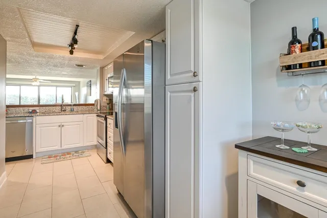 a kitchen with stainless steel appliances granite countertop a refrigerator and a sink