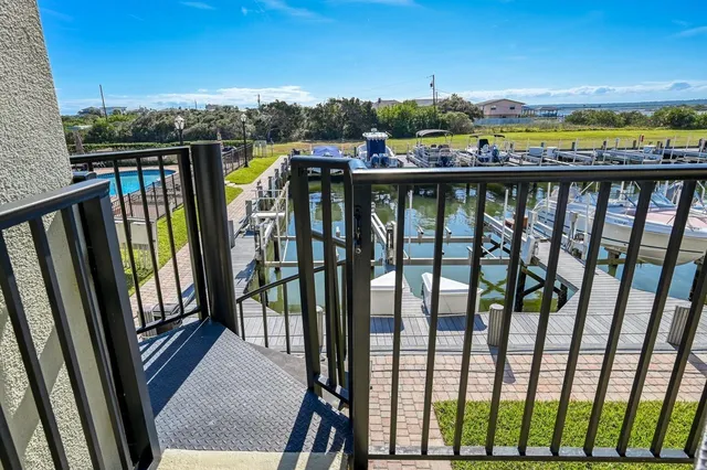 a view of a swimming pool with couches and wooden floor