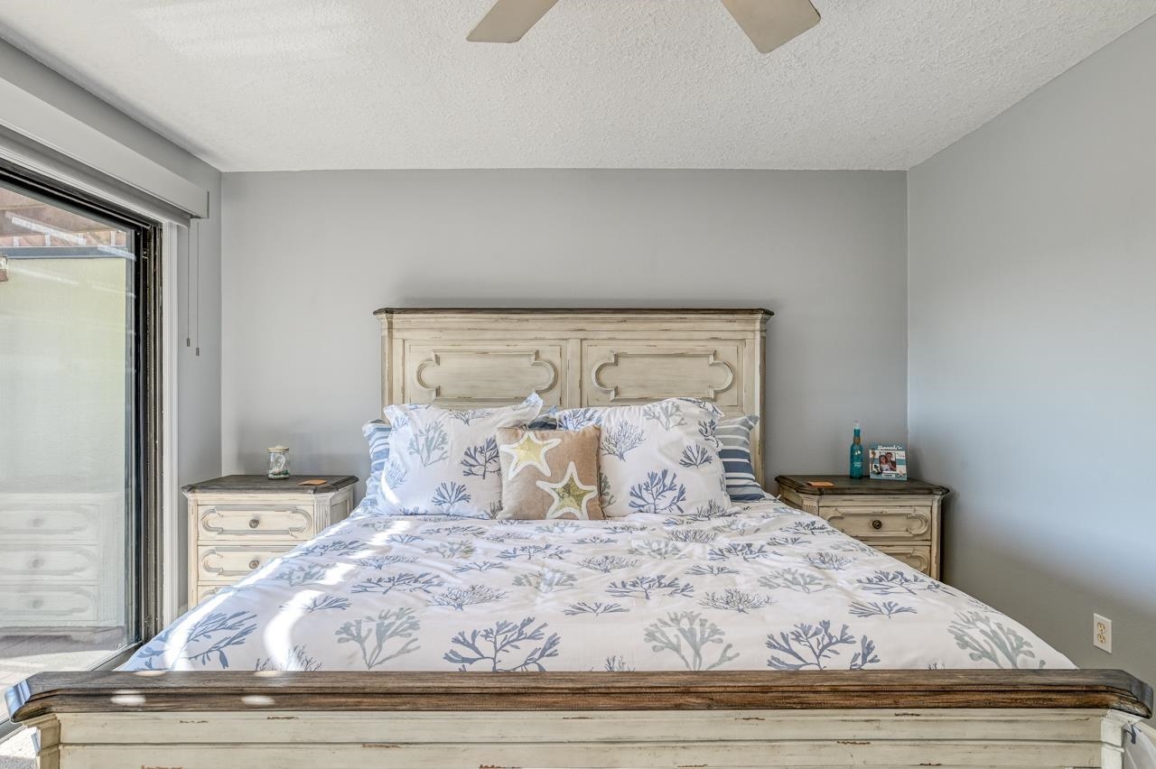 120 Sunset Harbor Way, Unit 204 St. Augustine, FL 32080 - Photo 30 of 49 a bedroom with a bed and wooden floor
