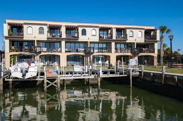 a front view of houses with a lake view and boat