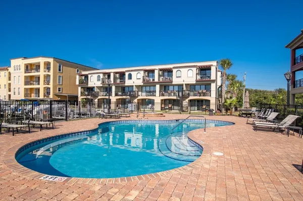 a view of a swimming pool with outdoor seating