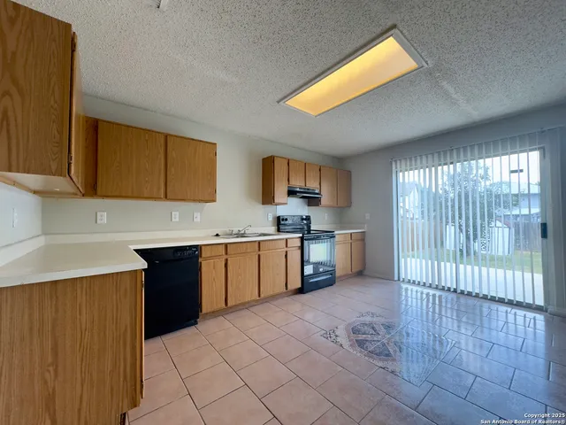 a kitchen with a sink cabinets and appliances