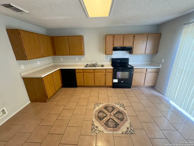 a kitchen with a cabinets and window