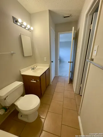 a bathroom with a sink a toilet a mirror and vanity