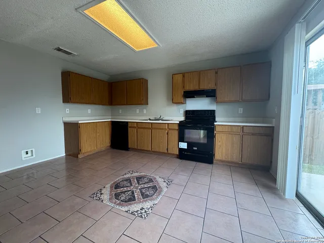 a kitchen with stainless steel appliances a sink and cabinets