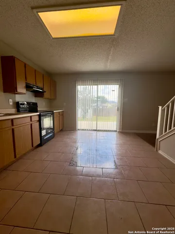 a view of a kitchen with an empty space and a sink