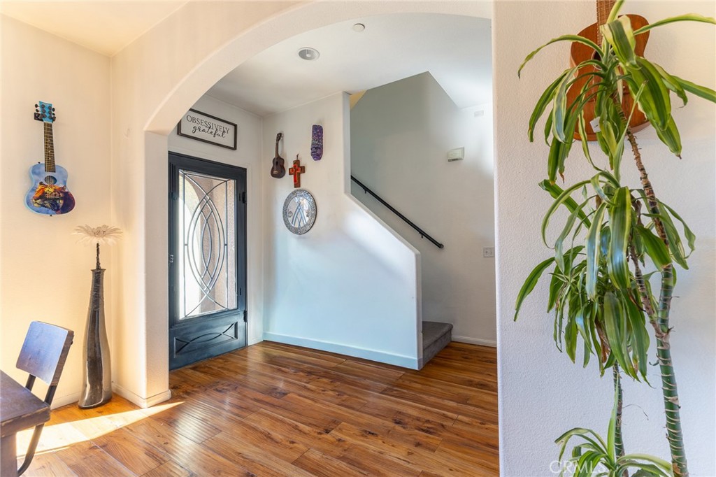 14176 Kiowa Road Apple Valley, CA 92307 - Photo 13 of 54 a view of a hallway with wooden floor and stairs