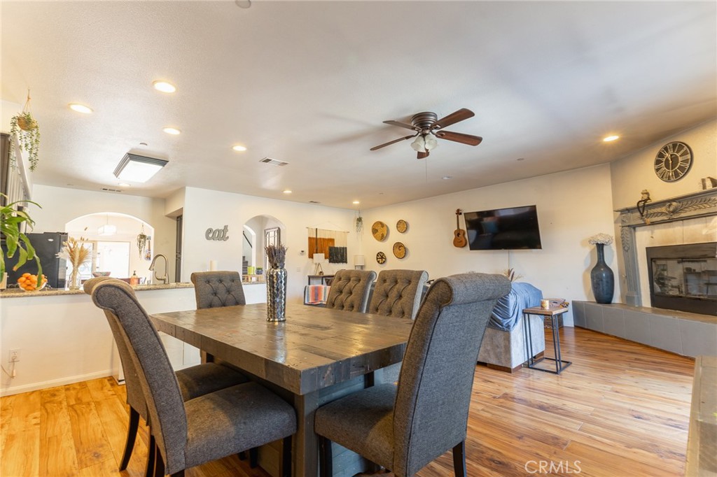 14176 Kiowa Road Apple Valley, CA 92307 - Photo 16 of 54 a view of a dining room with furniture and wooden floor