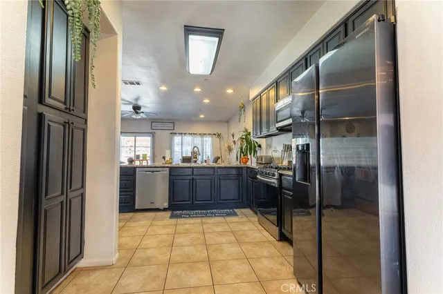 a kitchen with granite countertop stainless steel appliances and wooden cabinets