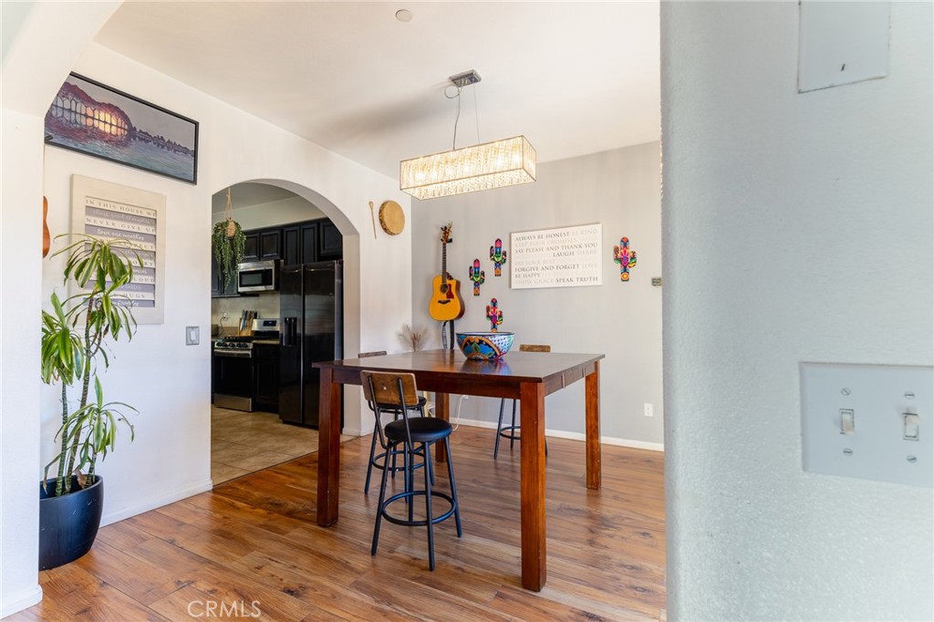 14176 Kiowa Road Apple Valley, CA 92307 - Photo 26 of 54 a view of a dining room with furniture window and wooden floor