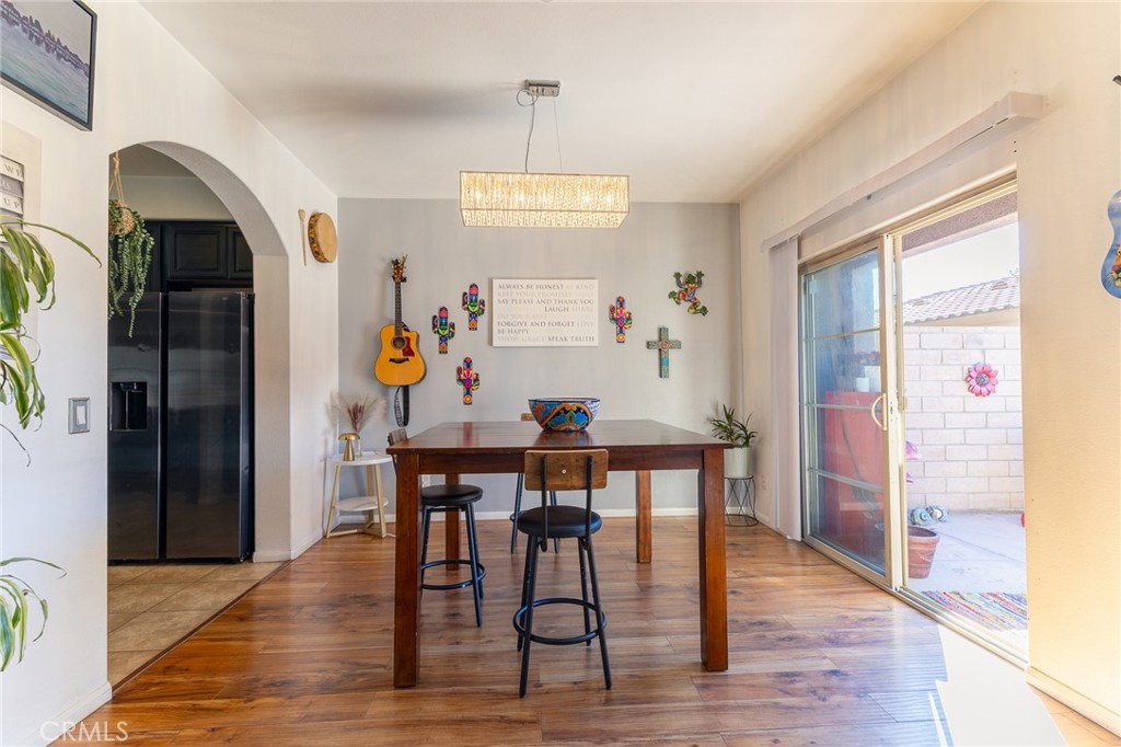 14176 Kiowa Road Apple Valley, CA 92307 - Photo 27 of 54 a view of a dining room with furniture window and wooden floor