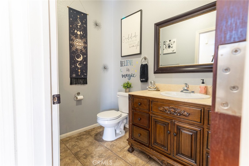 14176 Kiowa Road Apple Valley, CA 92307 - Photo 30 of 54 a spacious bathroom with a sink toilet and mirror