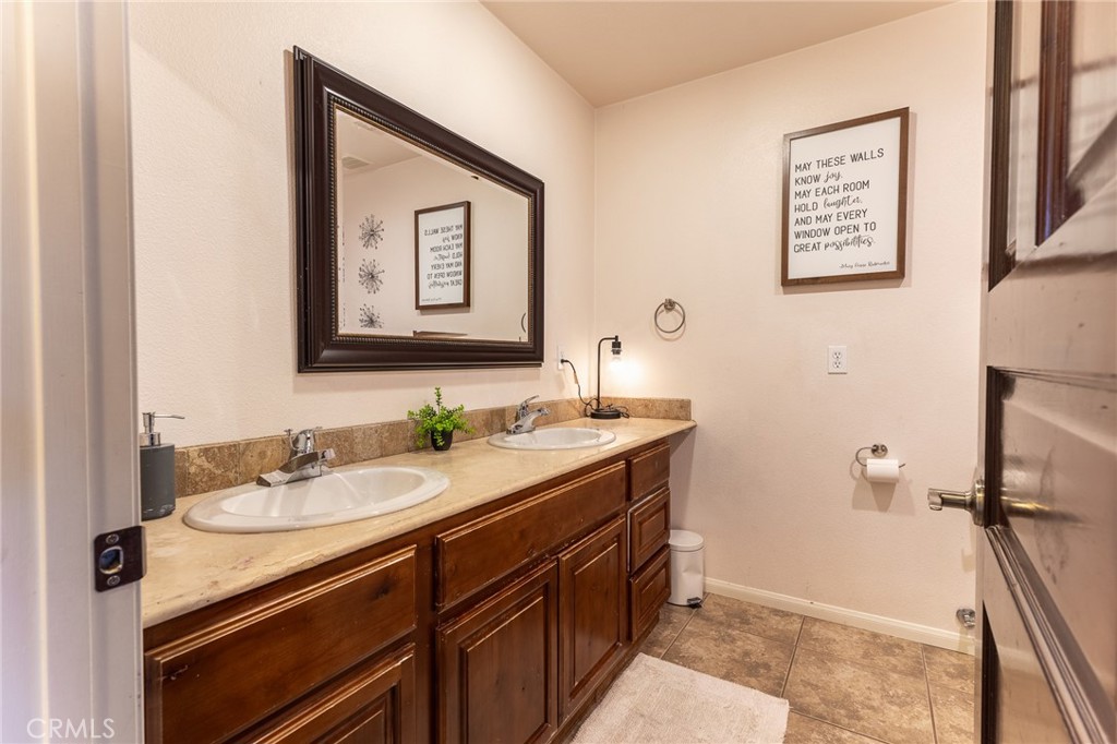 14176 Kiowa Road Apple Valley, CA 92307 - Photo 32 of 54 a bathroom with a sink and a mirror