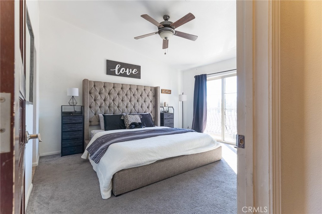 14176 Kiowa Road Apple Valley, CA 92307 - Photo 36 of 54 a bedroom with a bed and a chandelier