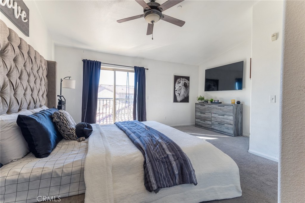 14176 Kiowa Road Apple Valley, CA 92307 - Photo 38 of 54 a bedroom with a bed and a flat screen tv