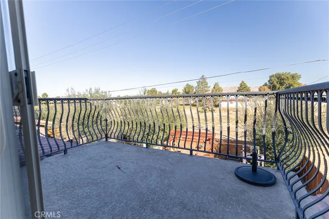 a view of a hallway with wooden floor and a potted plant