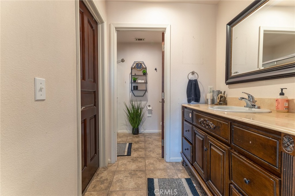 14176 Kiowa Road Apple Valley, CA 92307 - Photo 40 of 54 a bathroom with a sink and a mirror