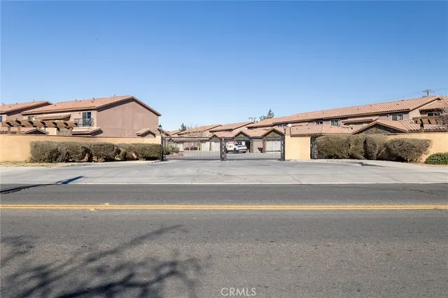 a view of a house and a car parked on the road