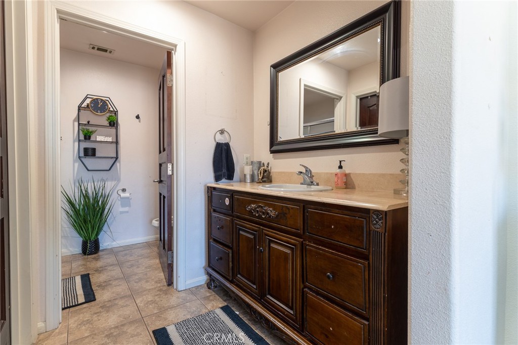 14176 Kiowa Road Apple Valley, CA 92307 - Photo 41 of 54 a bathroom with a sink and a mirror