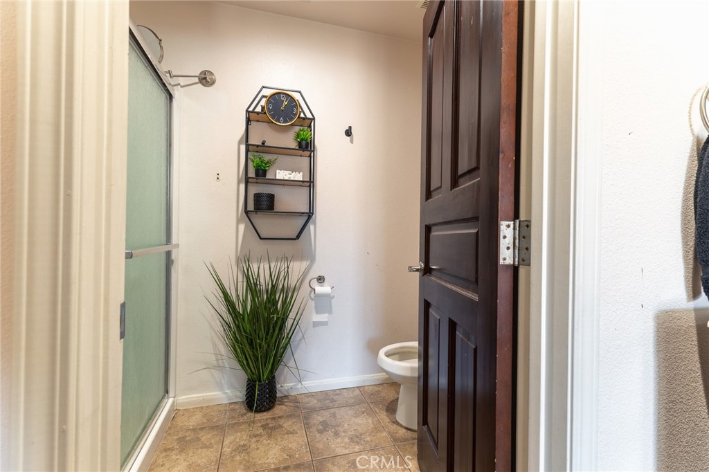 14176 Kiowa Road Apple Valley, CA 92307 - Photo 43 of 54 a view of a hallway with wooden floor and a potted plant