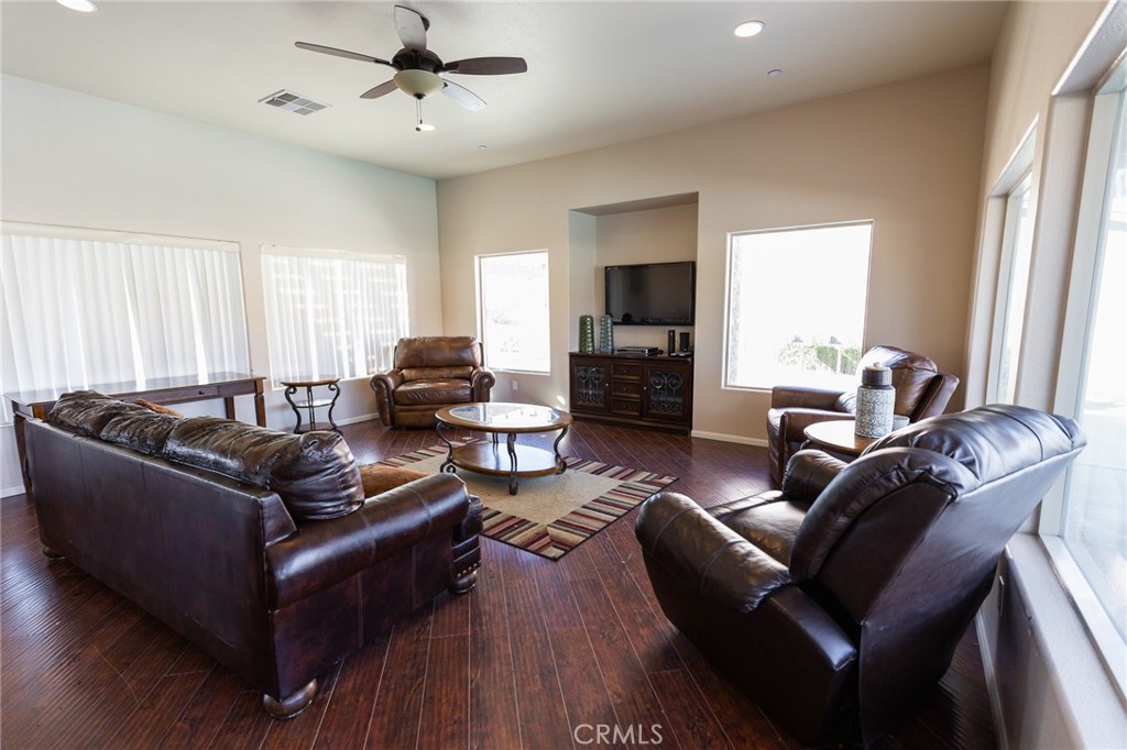 14176 Kiowa Road Apple Valley, CA 92307 - Photo 51 of 54 a living room with furniture and a flat screen tv