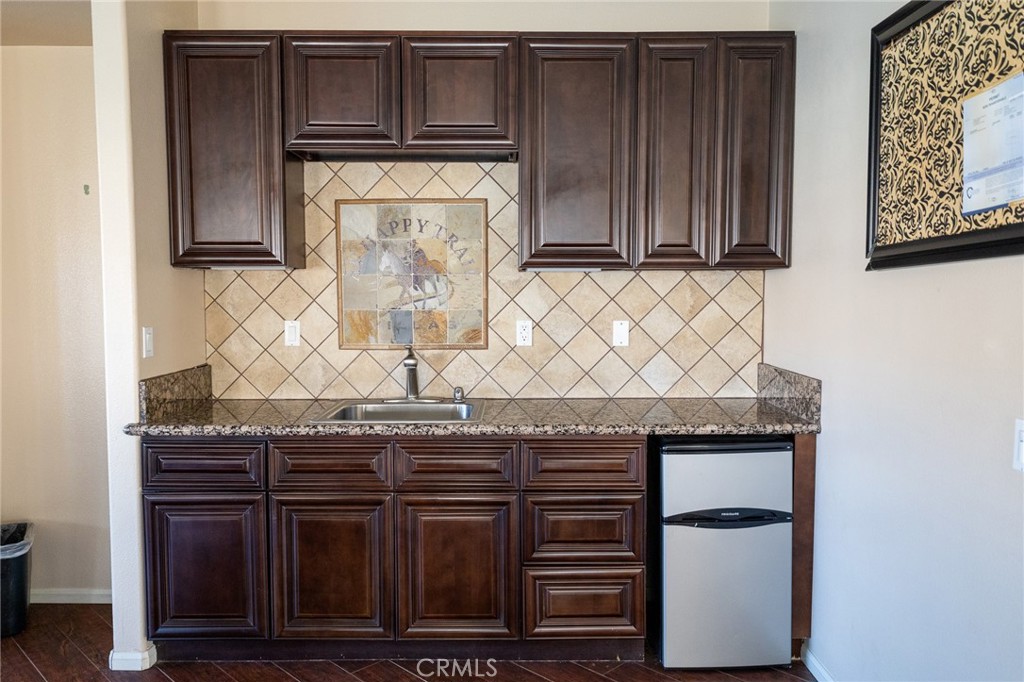 14176 Kiowa Road Apple Valley, CA 92307 - Photo 54 of 54 a kitchen with granite countertop a wooden cabinets and a sink